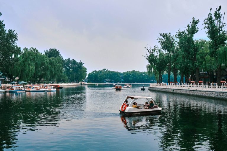 The lake at Shichahai has many visitors rowing boats.