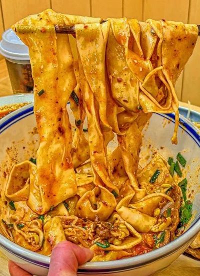 Biangbiang Noodles 2-Food Guide-Xi’an Biangbiang noodles are a famous specialty in Xi'an, celebrated for their wide, chewy noodles and rich, spicy broth.