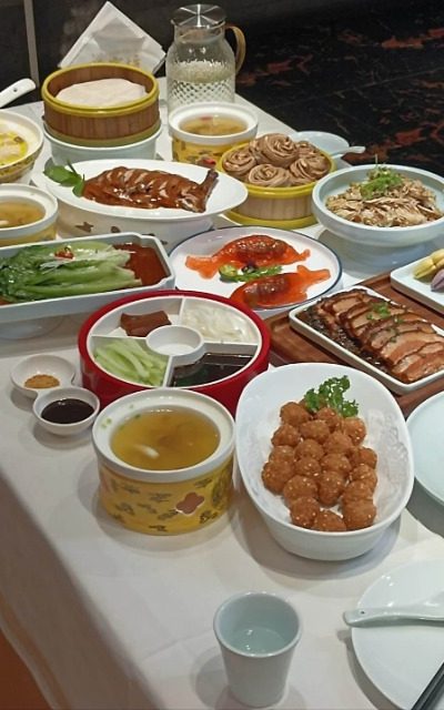 Bianyifang Restaurant-Food Guide-Beijing A table full of sumptuous Beijing dishes at Bianyifang Restaurant in Beijing.