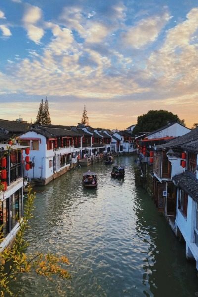 Boat-Zhujiajiao-Shanghai Tourists leisurely cruise along the river in Zhouzhuang Ancient Town, enjoying the sights from their boats.