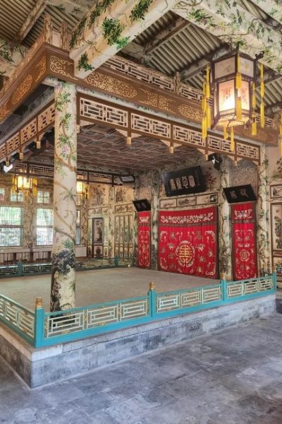 Da Xi Lou (Grand Theatre)-Prince Kung’s Palace Museum-Beijing The columns of the theater stage are intricately carved and decorated with beautiful patterns, with two vintage Chinese lanterns beside them.