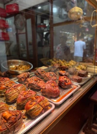 Restaurant 1-Zhujiajiao-Shanghai The restaurant's window showcases a variety of traditional Chinese dishes, including braised pig's trotters.