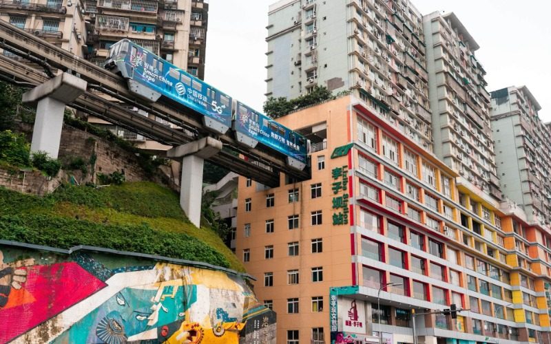 View 1-Liziba Station-Chongqing The scene of trains passing through residential buildings at Liziba Metro Station in Chongqing.