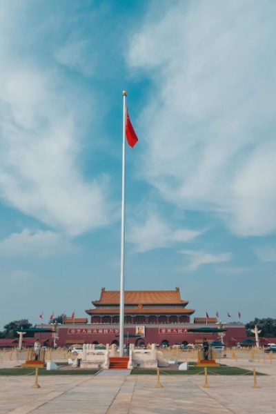five-star red flag-Tiananmen-Beijing The five-star red flag of China flutters in the wind atop the flagpole at Tiananmen.